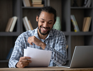 Smiling Man reading a resume